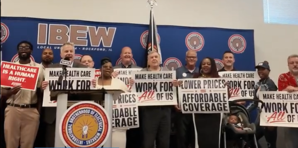 Union members at IBEW Local 364 in Rockford, Illinois holding Make Health Care Work for All of Us signs