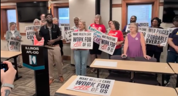 Advocates at the Illinois AFL-CIO holding campaign signs